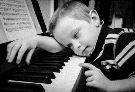 Sad boy with piano