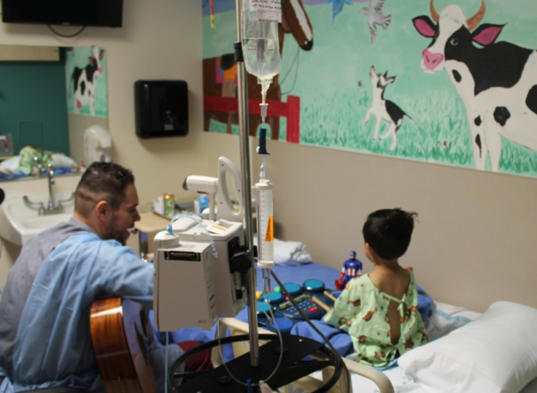 Music Therapist with Child at Hospital